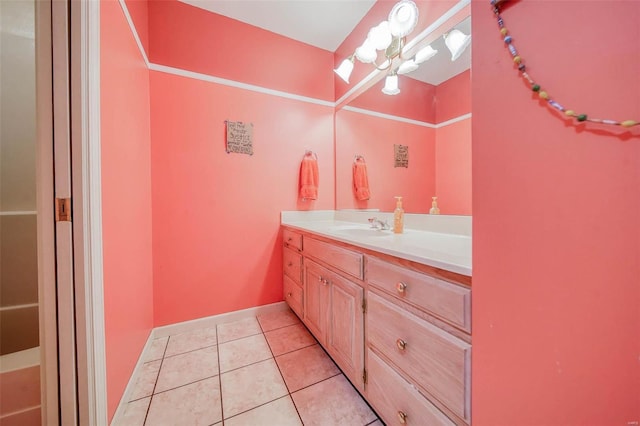 bathroom with tile patterned floors, a chandelier, and vanity