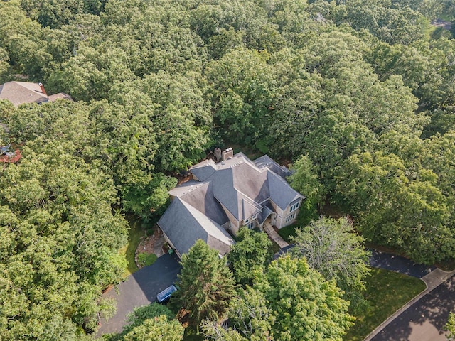 birds eye view of property with a wooded view