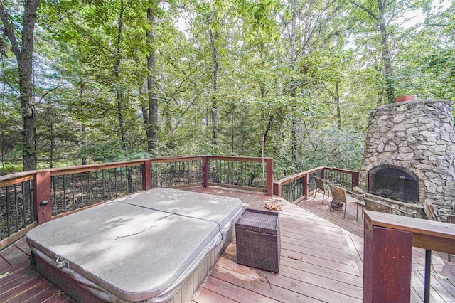 wooden deck featuring an outdoor stone fireplace