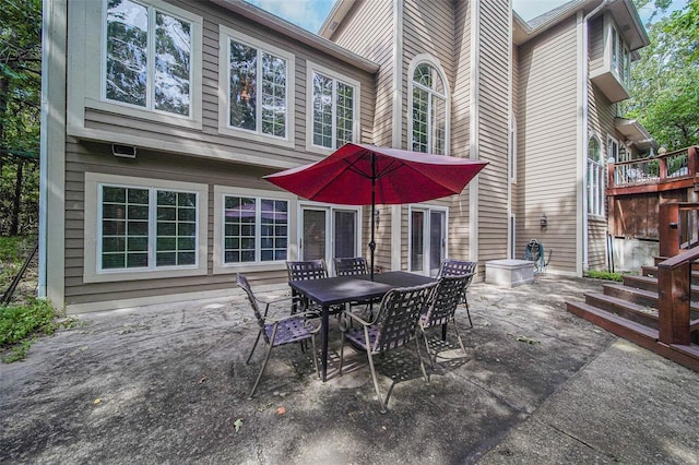 view of patio featuring outdoor dining space and stairway