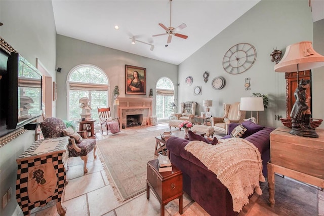 bedroom with high vaulted ceiling, a premium fireplace, and a ceiling fan