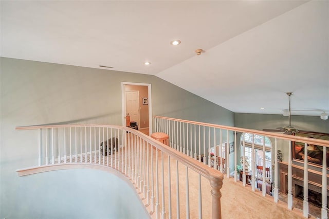 hallway with recessed lighting, carpet floors, visible vents, an upstairs landing, and vaulted ceiling