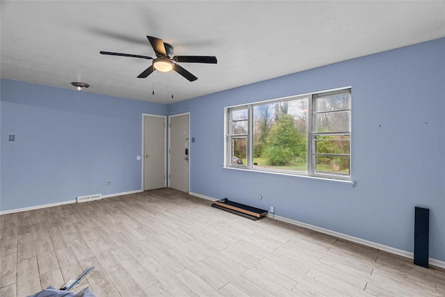 unfurnished room with ceiling fan and light wood-type flooring