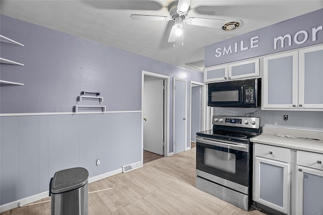 kitchen featuring white cabinets, electric range, tasteful backsplash, and ceiling fan