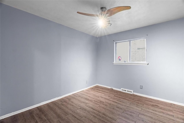 spare room featuring hardwood / wood-style floors and ceiling fan