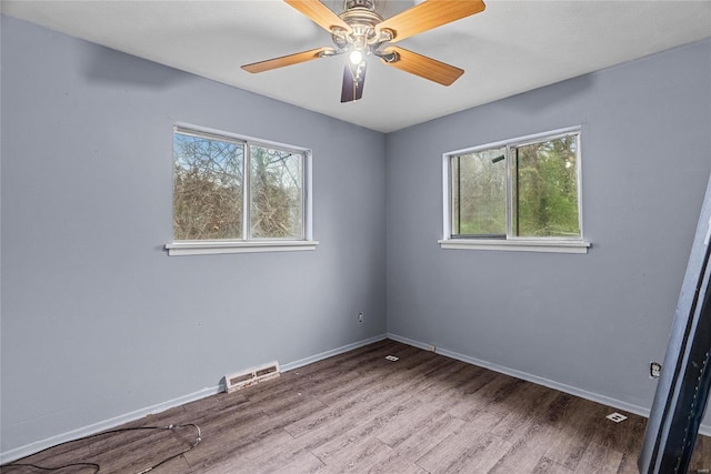 spare room with wood-type flooring and ceiling fan