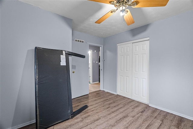 unfurnished bedroom with a closet, ceiling fan, and light hardwood / wood-style flooring