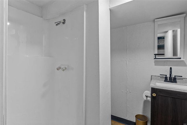 bathroom with a shower and vanity