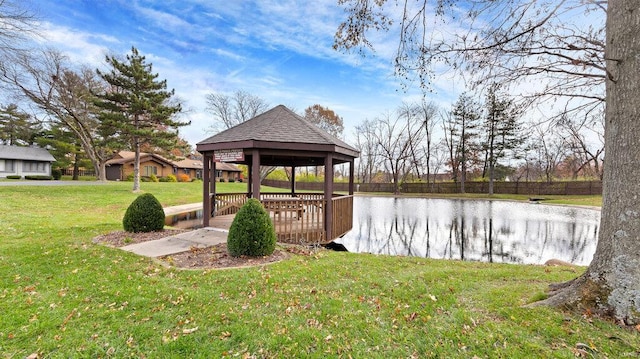 dock area featuring a gazebo, a yard, and a water view