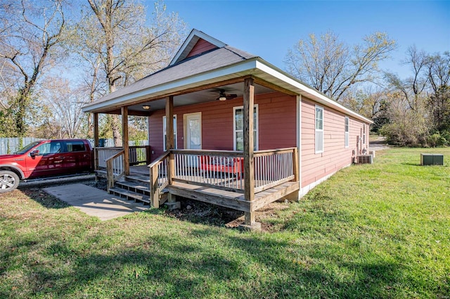 view of front of home featuring a porch, a front yard, and cooling unit