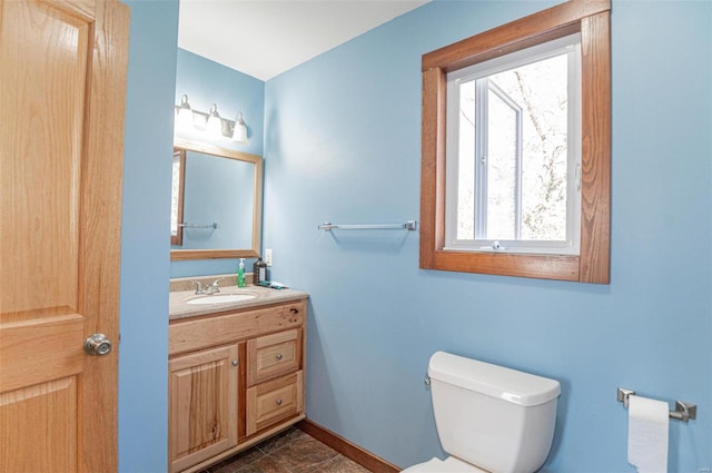 bathroom featuring vanity and toilet