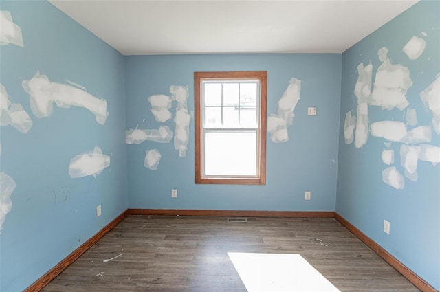 spare room featuring dark hardwood / wood-style floors