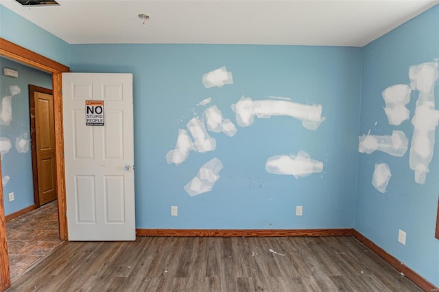 empty room featuring dark wood-type flooring