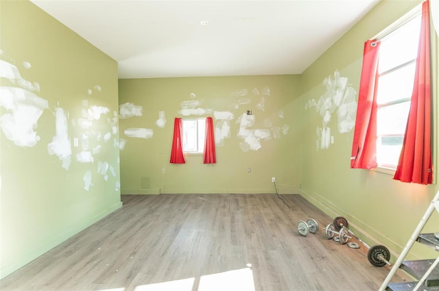 empty room with a healthy amount of sunlight and light wood-type flooring