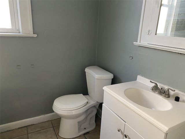 bathroom with tile patterned flooring, vanity, and toilet