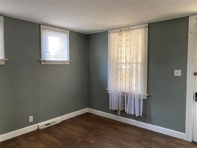 unfurnished room featuring dark wood-type flooring