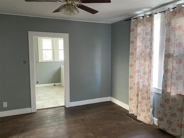 unfurnished room featuring ceiling fan and dark wood-type flooring