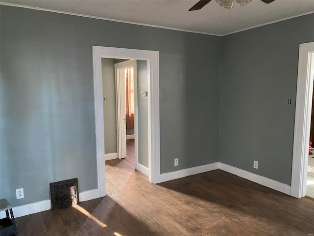 unfurnished room featuring ceiling fan, wood-type flooring, and ornamental molding