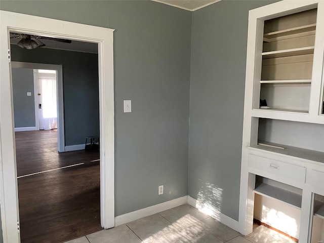 interior space with ceiling fan, built in features, and light hardwood / wood-style flooring