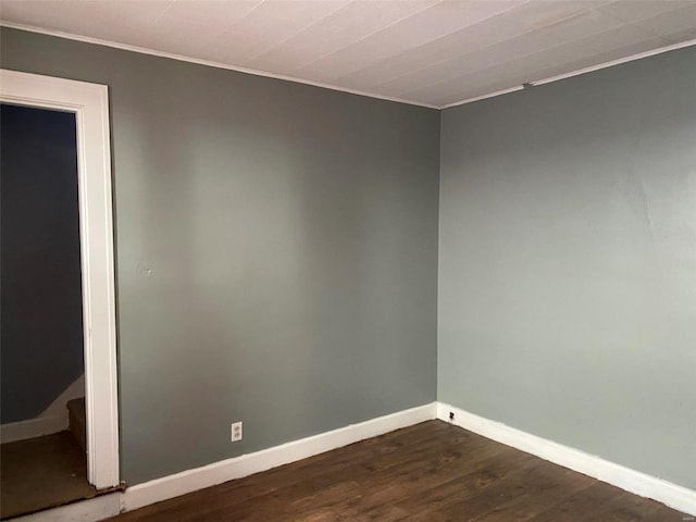 unfurnished room featuring dark hardwood / wood-style flooring and crown molding