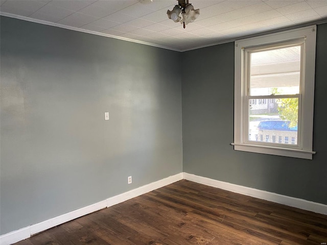 unfurnished room featuring crown molding and dark hardwood / wood-style flooring