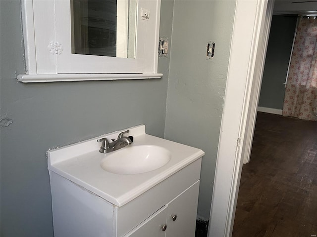 bathroom with hardwood / wood-style floors and vanity