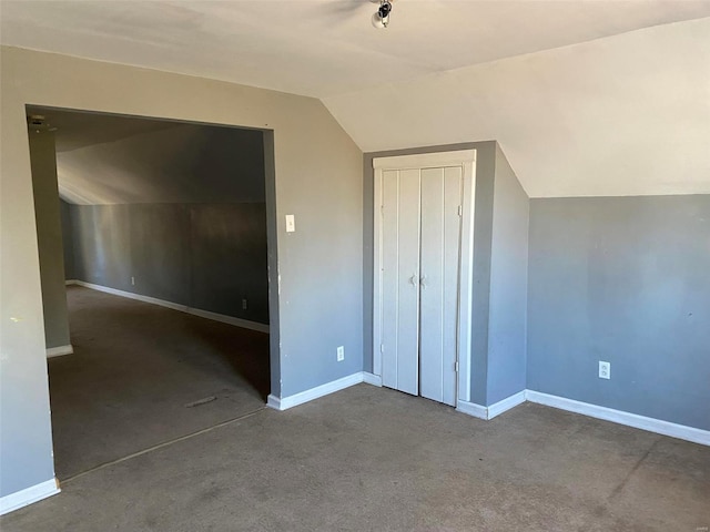 additional living space featuring carpet flooring and lofted ceiling