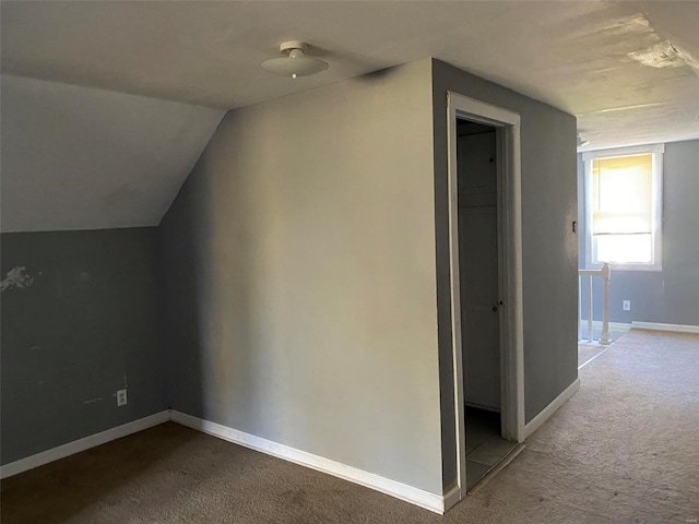 bonus room featuring light carpet and vaulted ceiling