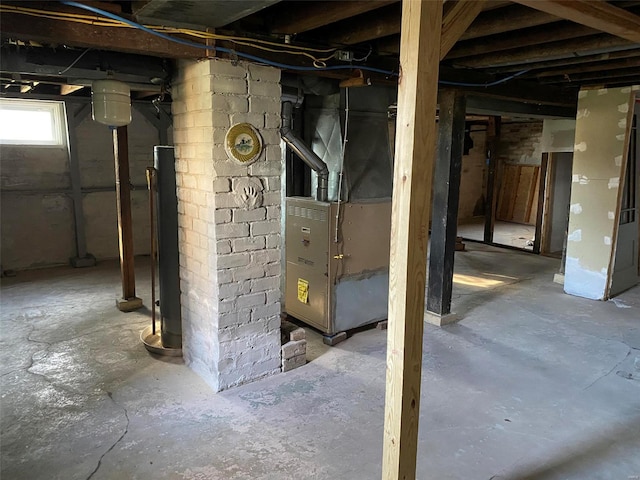 basement featuring heating unit and water heater