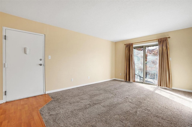 spare room with hardwood / wood-style floors and a textured ceiling