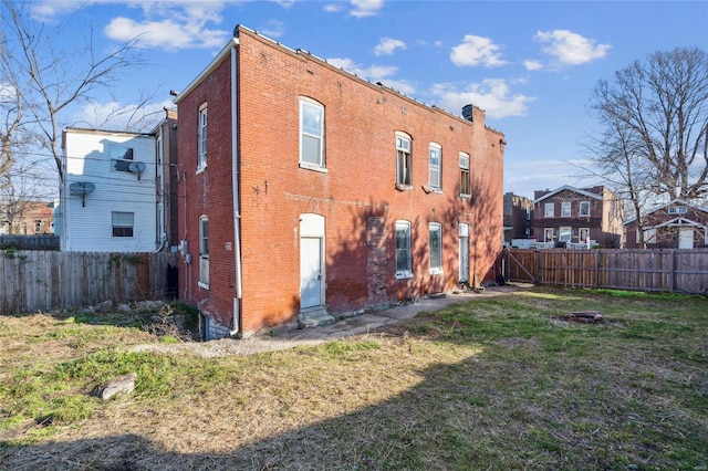 rear view of house with a lawn