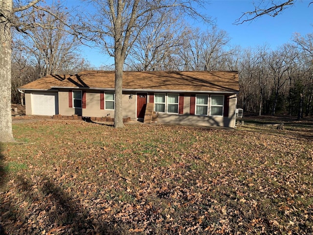 single story home featuring a front yard and a garage