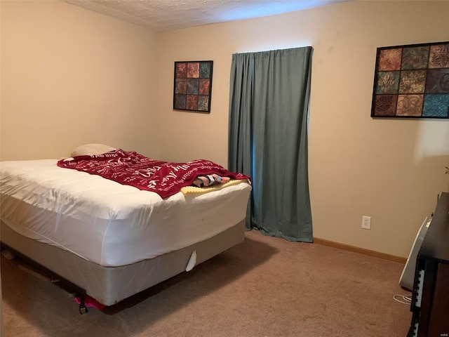 carpeted bedroom featuring a textured ceiling