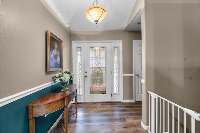 entrance foyer with dark hardwood / wood-style flooring and ornamental molding