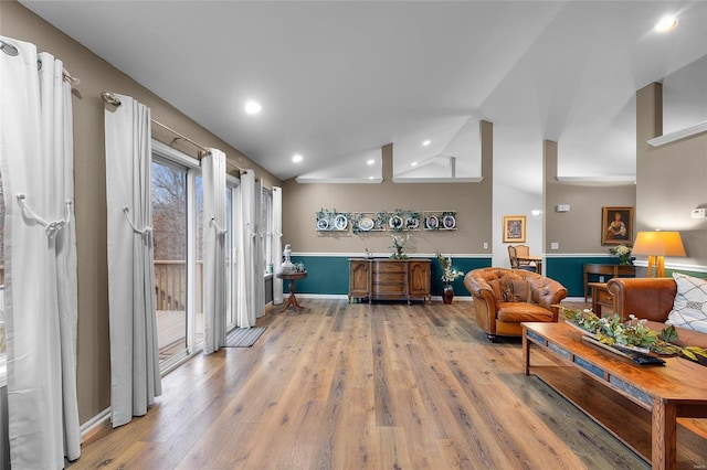 living room with hardwood / wood-style flooring and high vaulted ceiling