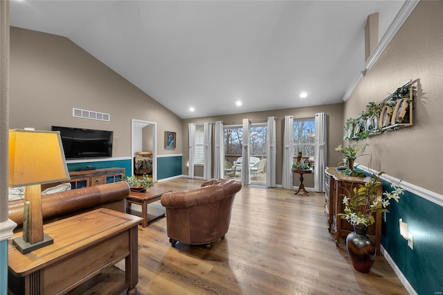 living room featuring light wood-type flooring and vaulted ceiling