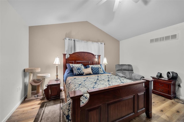 bedroom with ceiling fan, light hardwood / wood-style flooring, and lofted ceiling