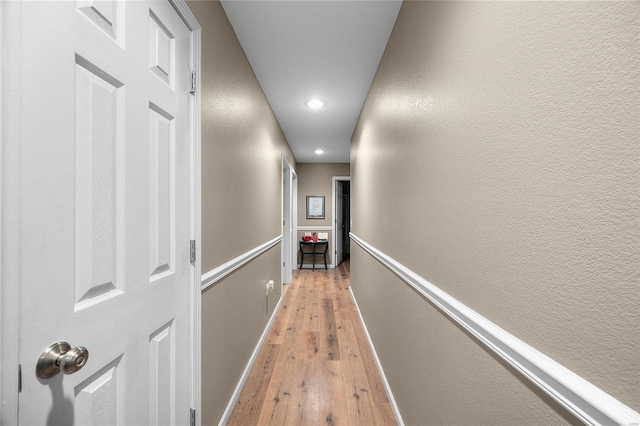 hall with light hardwood / wood-style flooring