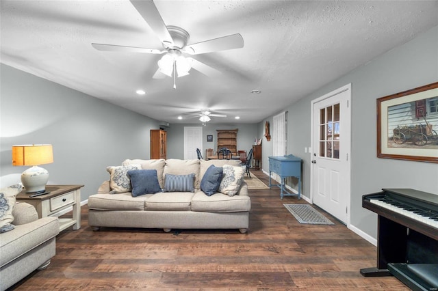 living room featuring a textured ceiling, dark hardwood / wood-style floors, and ceiling fan