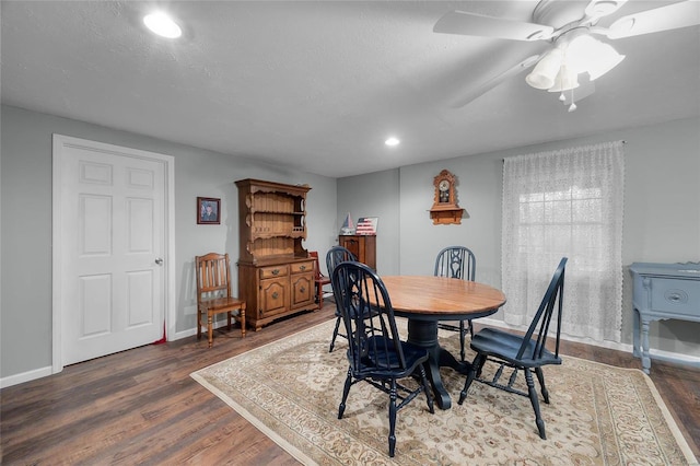 dining space featuring ceiling fan and dark hardwood / wood-style flooring