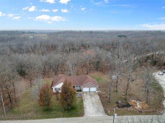 drone / aerial view featuring a wooded view