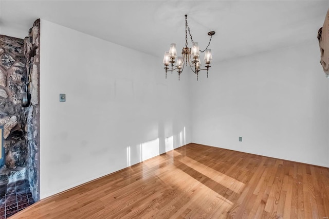 unfurnished dining area featuring hardwood / wood-style flooring and a chandelier