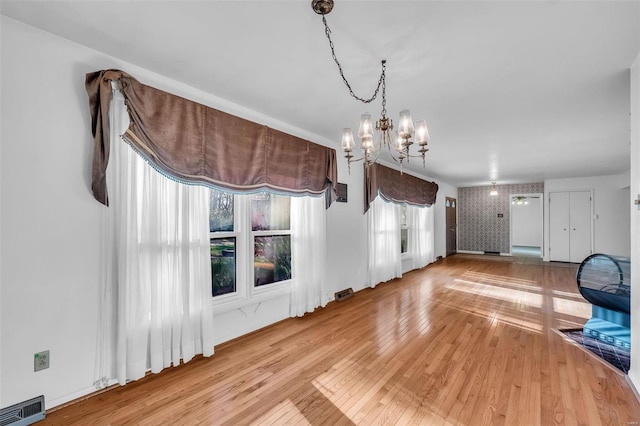 interior space featuring hardwood / wood-style flooring and a notable chandelier