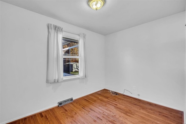 unfurnished room featuring wood-type flooring