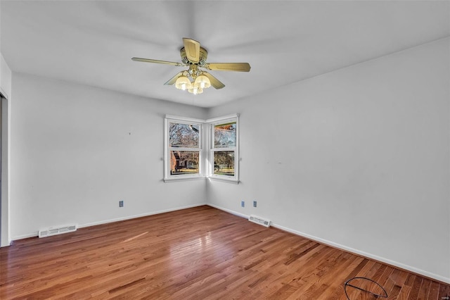 empty room with ceiling fan and hardwood / wood-style floors