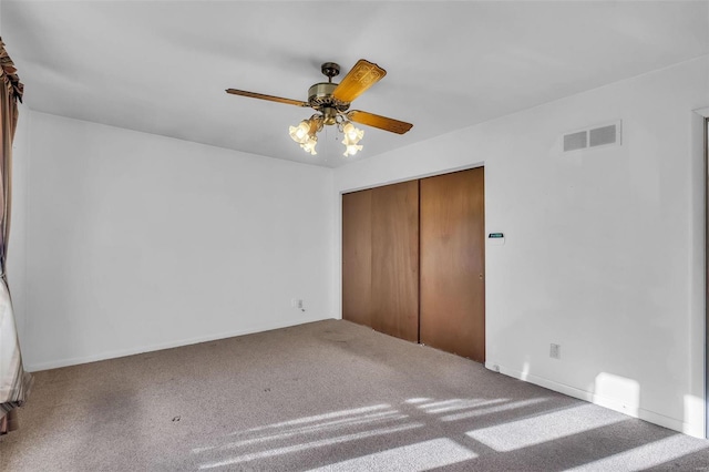 unfurnished bedroom with a closet, ceiling fan, and carpet flooring