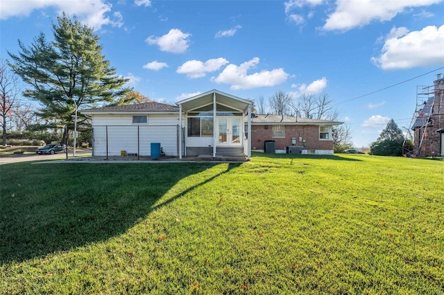 back of house featuring a yard