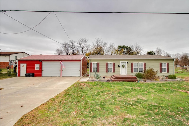 ranch-style home with an outbuilding, a garage, and a front lawn