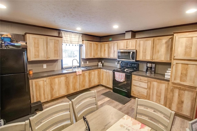 kitchen with light brown cabinets, sink, a textured ceiling, and black appliances