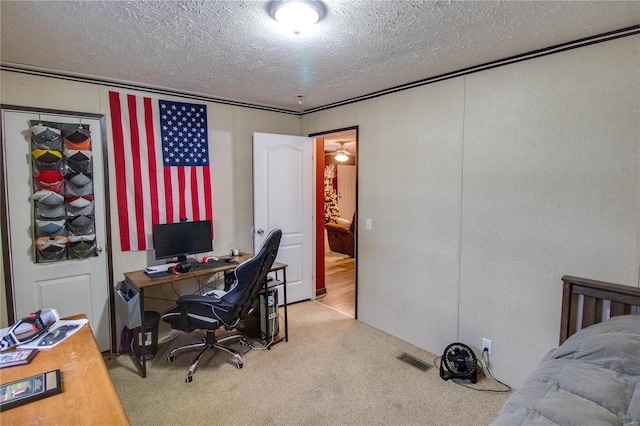 office with carpet flooring and a textured ceiling